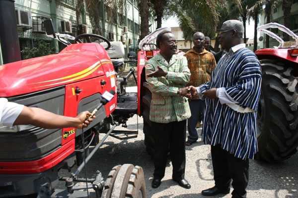 Mr Kwesi Ahwoi, Minister of Agriculture presenting a tractor to Dr Isaac Kofi Adjei-Maafo, Former Minister of Agriculture in 1985-1986  - Kwesi Ahwoi