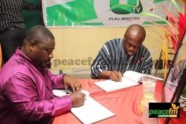 Okyeame Quophi and Honorable Omane Boamah signing the book of condolence    - Okyeame Quophi